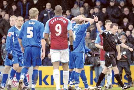 The Gills players look on in dismay as referee Keith Stroud awards Aston Villa a penalty
