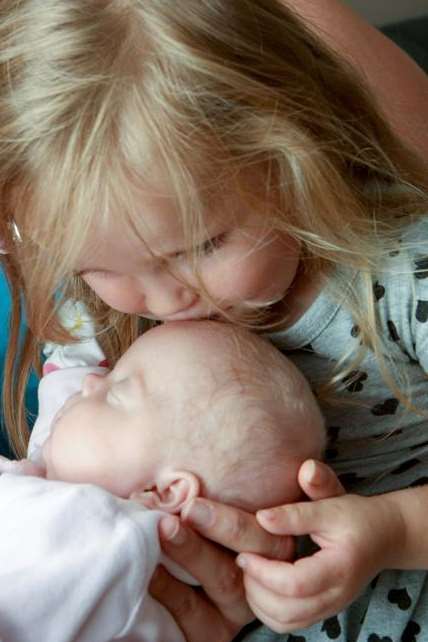 Daisy's cousin Lily, 2, gives the little fighter a kiss