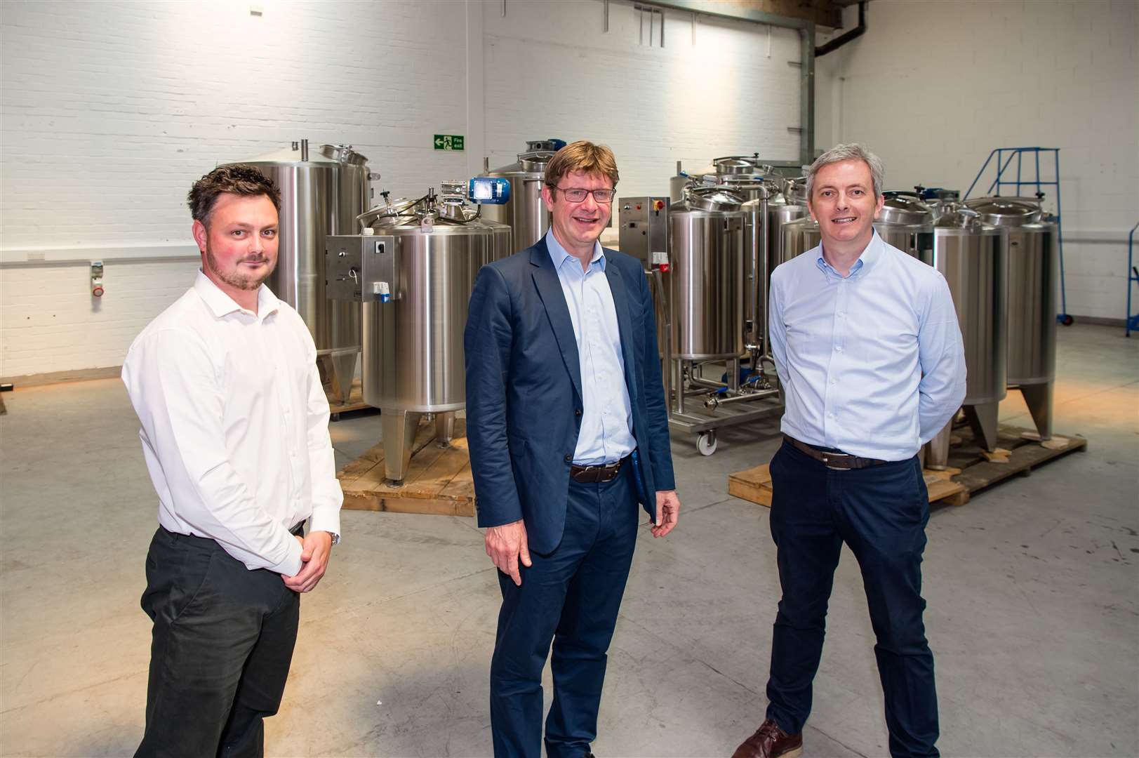 Warehouse manager Nathan Biginton with Greg Clark, MP, and managing director Colin Wilson