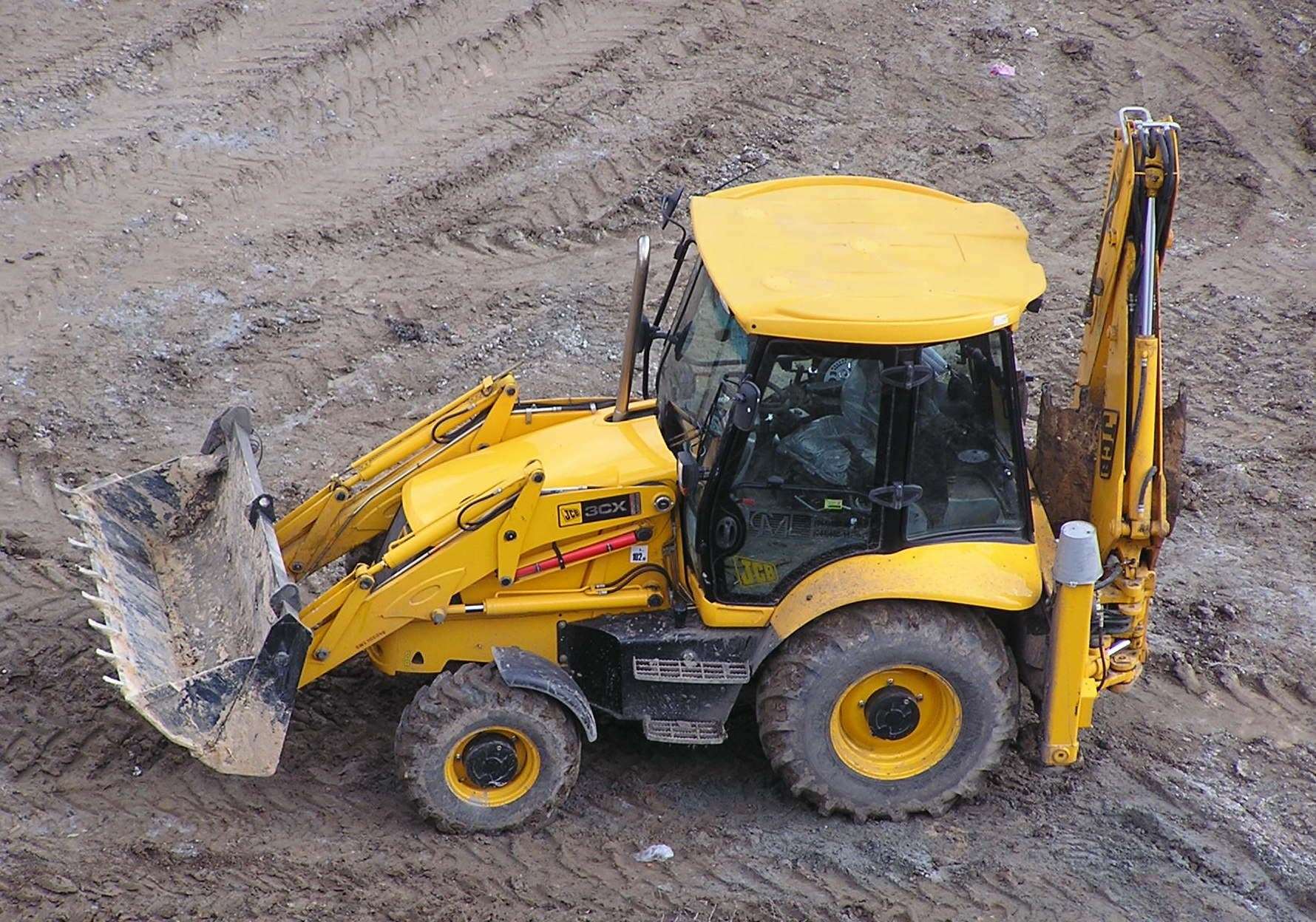The employee had half his body run over by a JCB. Stock image