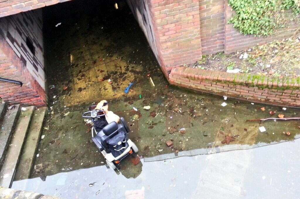 A woman was rescued from her mobility scooter after breaking down in a puddle. Picture @SamThomas871