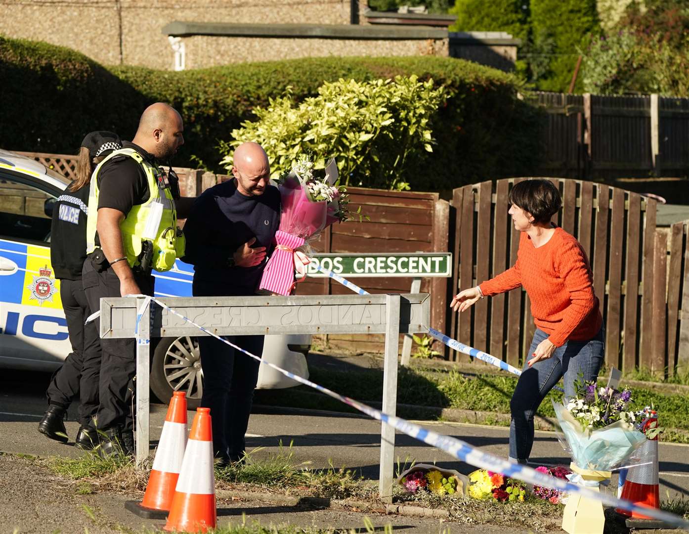 The father to some of the victims leaves flowers at the scene in Chandos Crescent (Danny Lawson/PA)