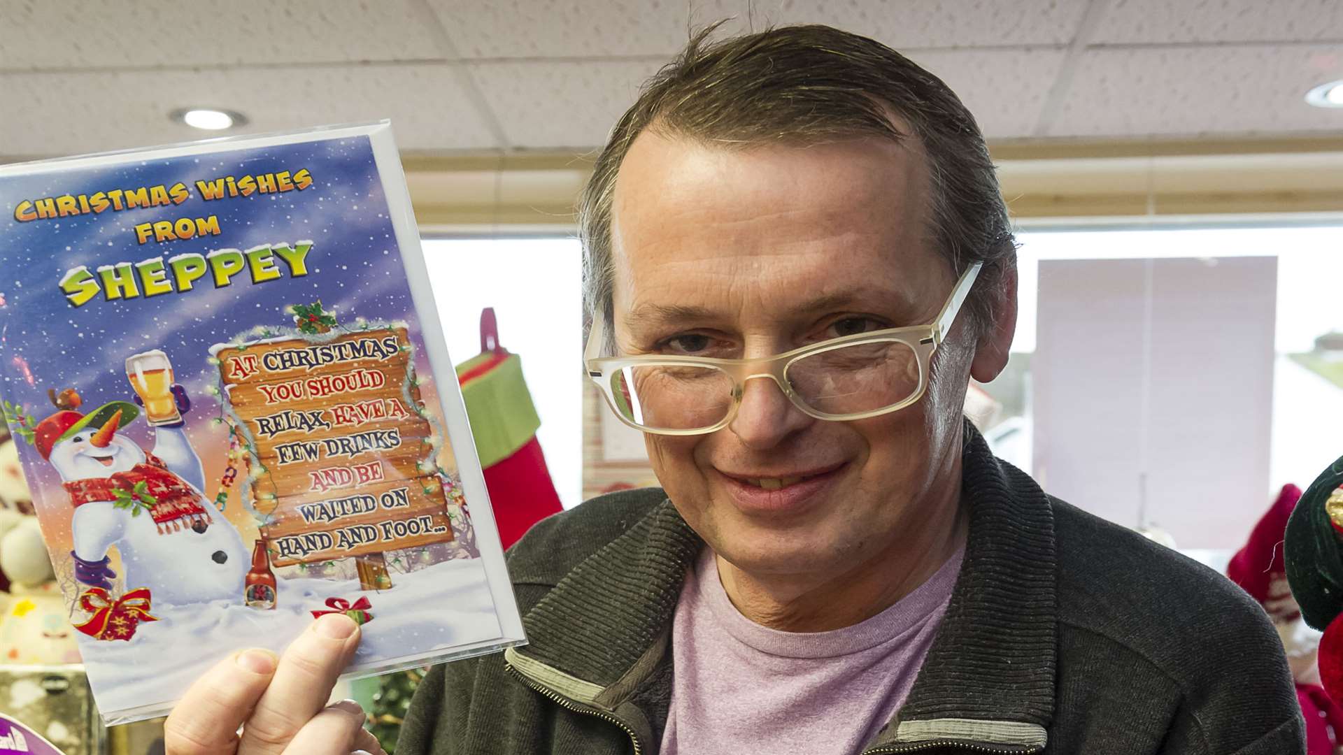 Spreading the word: Shopkeeper Patrick Altimas with a selection of his Sheppey Christmas cards