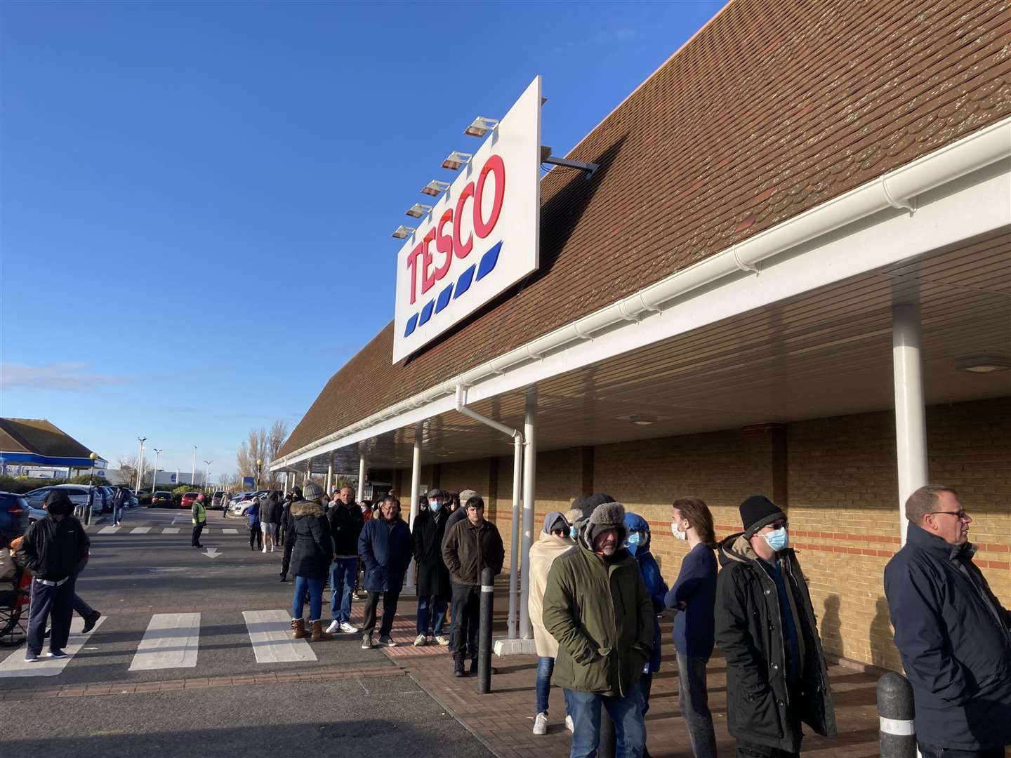 Queue to have a Covid booster jab stretched around Tesco supermarket in Bridge Road, Sheerness