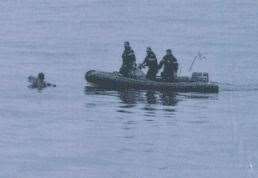 Rescuers in a dinghy reach the swimmer. Picture: Préfecture Maritime de la Manche et de la mer du Nord,