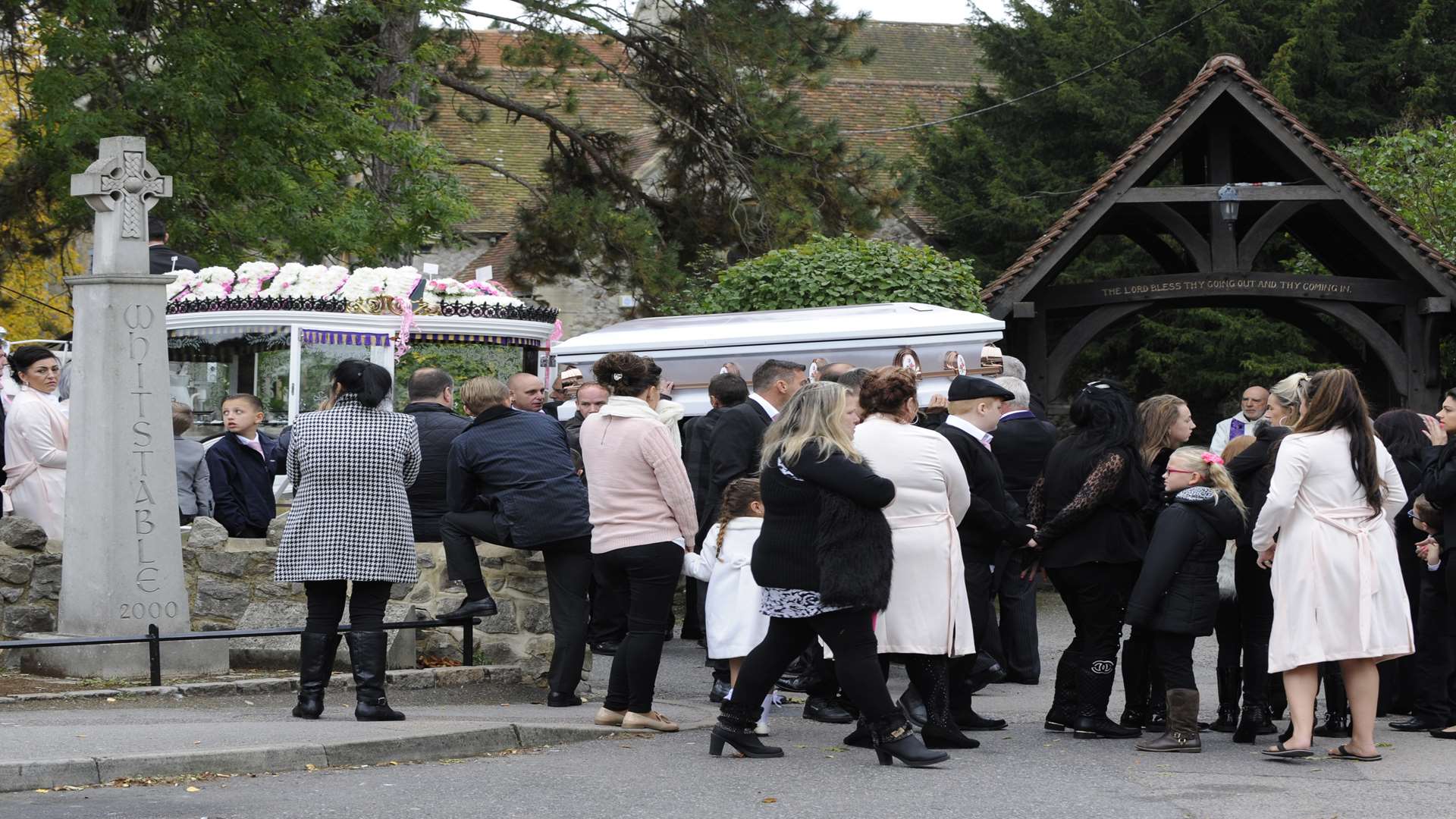 Mourners go in for the service