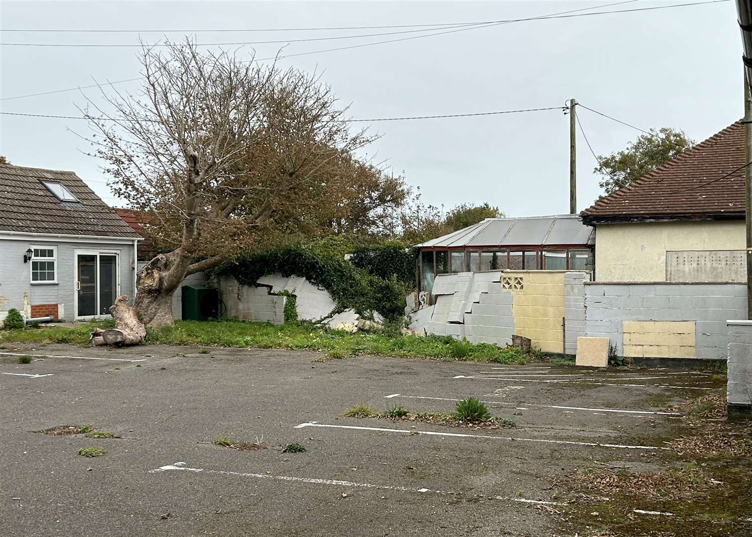 A wall has collapsed into a garden at the Lighthouse Inn based in Capel-le-Ferne