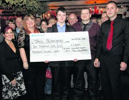 Jack Blanchard and his parents receive the cheque for £2,600