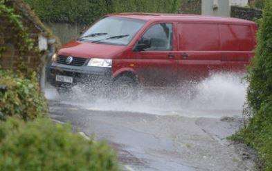 A van battling through the rainwater in Hogrbook Hill, Alkham. Picture: Paul Amos.