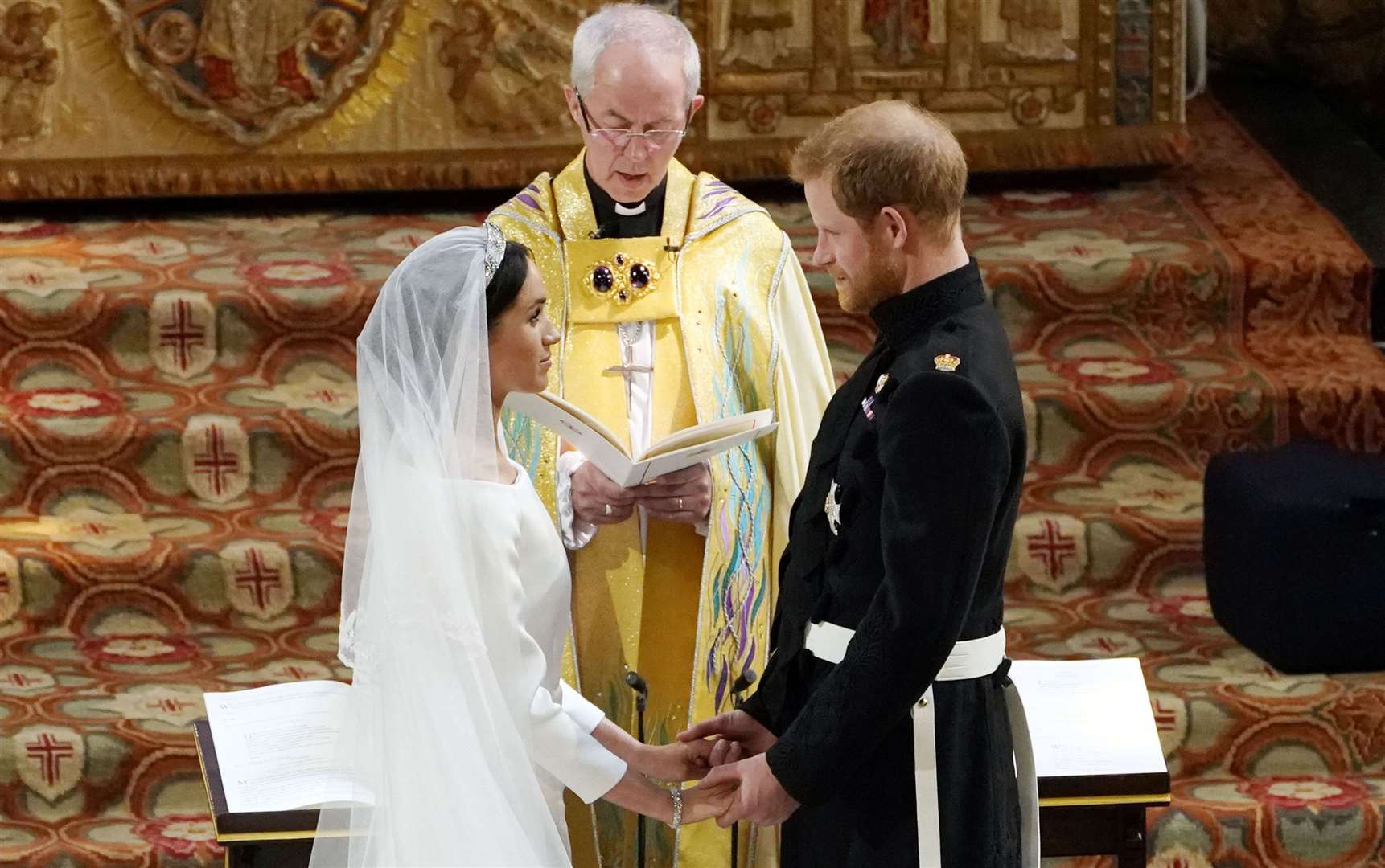 Prince Harry and Meghan Markle exchange vows in St George's Chapel at Windsor Castle conducted by the Archbishop of Canterbury Justin Welby. Photo credit Owen Humphreys/PA Wire.
