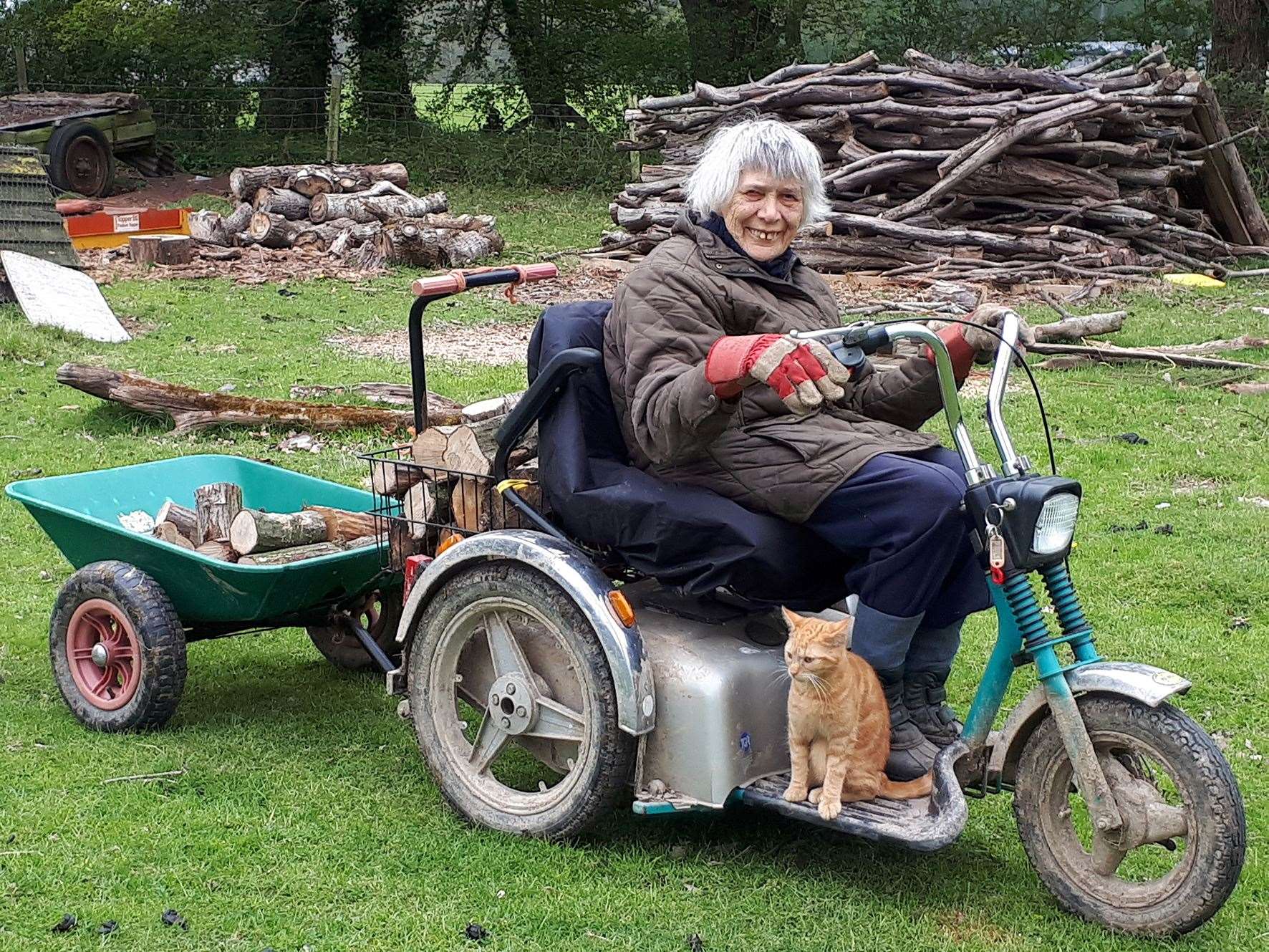 Farmer Marion Pont, 87, from Bethersden, on her trusty TGA Supersport mobility scooter with her cat Henry