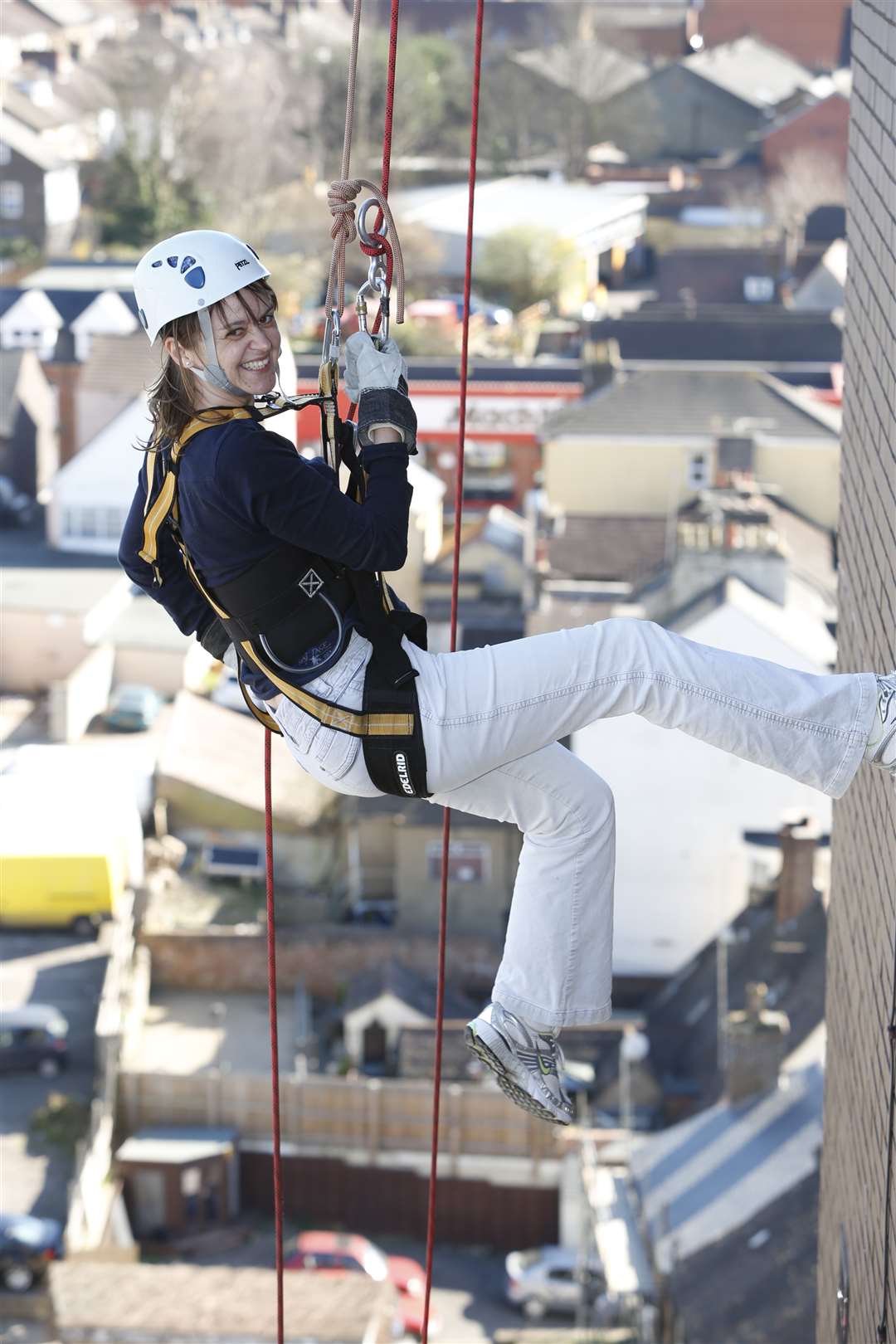 Ann-Marie Langley from event sponsor DSH on the way down during last year's KM abseil challenge at Miller House, Maidstone.