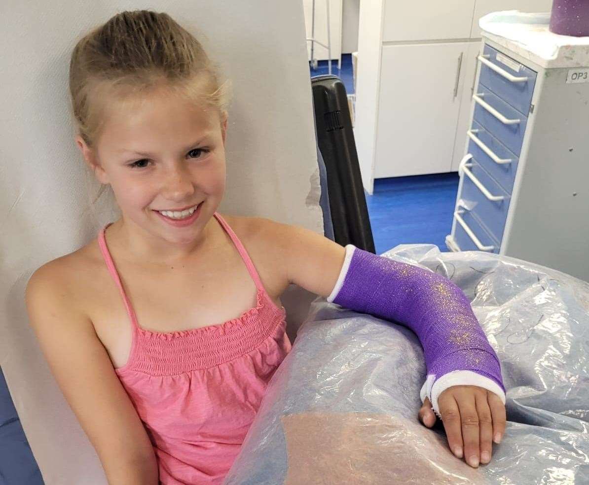 Tamzin Everett, 10, in hospital with her left arm in a cast two weeks after breaking it on a slide in the sandbox at Beachfields, Sheerness