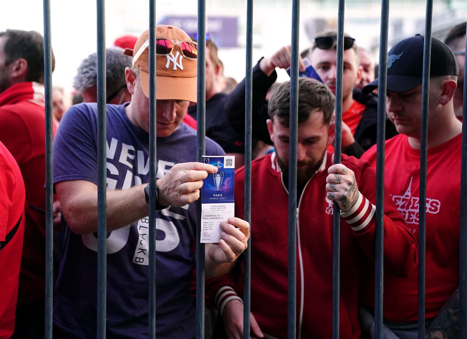 Liverpool fans stuck outside the ground show their match tickets (Adam Davy/PA)