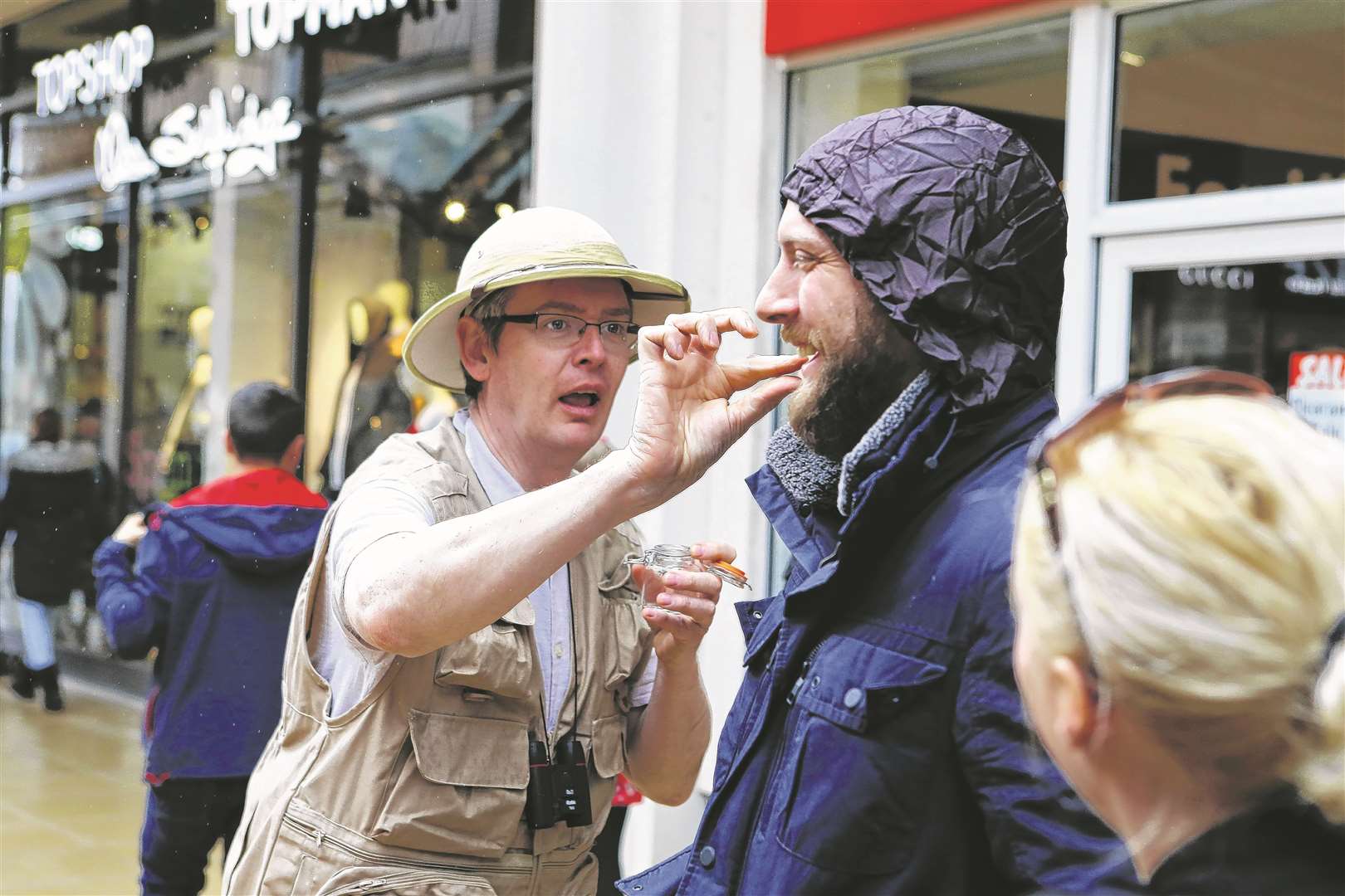 An eccentric explorer inspects a shopper as part of Looping the Loop festival