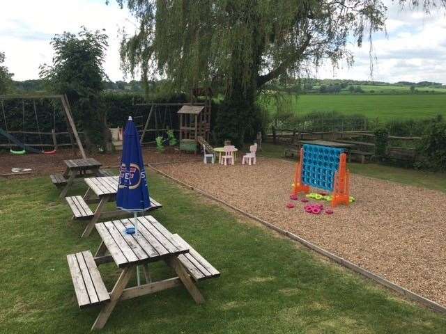 The bottom end of the pub garden has been turned over to the kids with swings, a climbing frame and other games