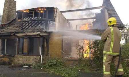 Firefighters bring the blaze under control. Picture: GRANT FALVEY
