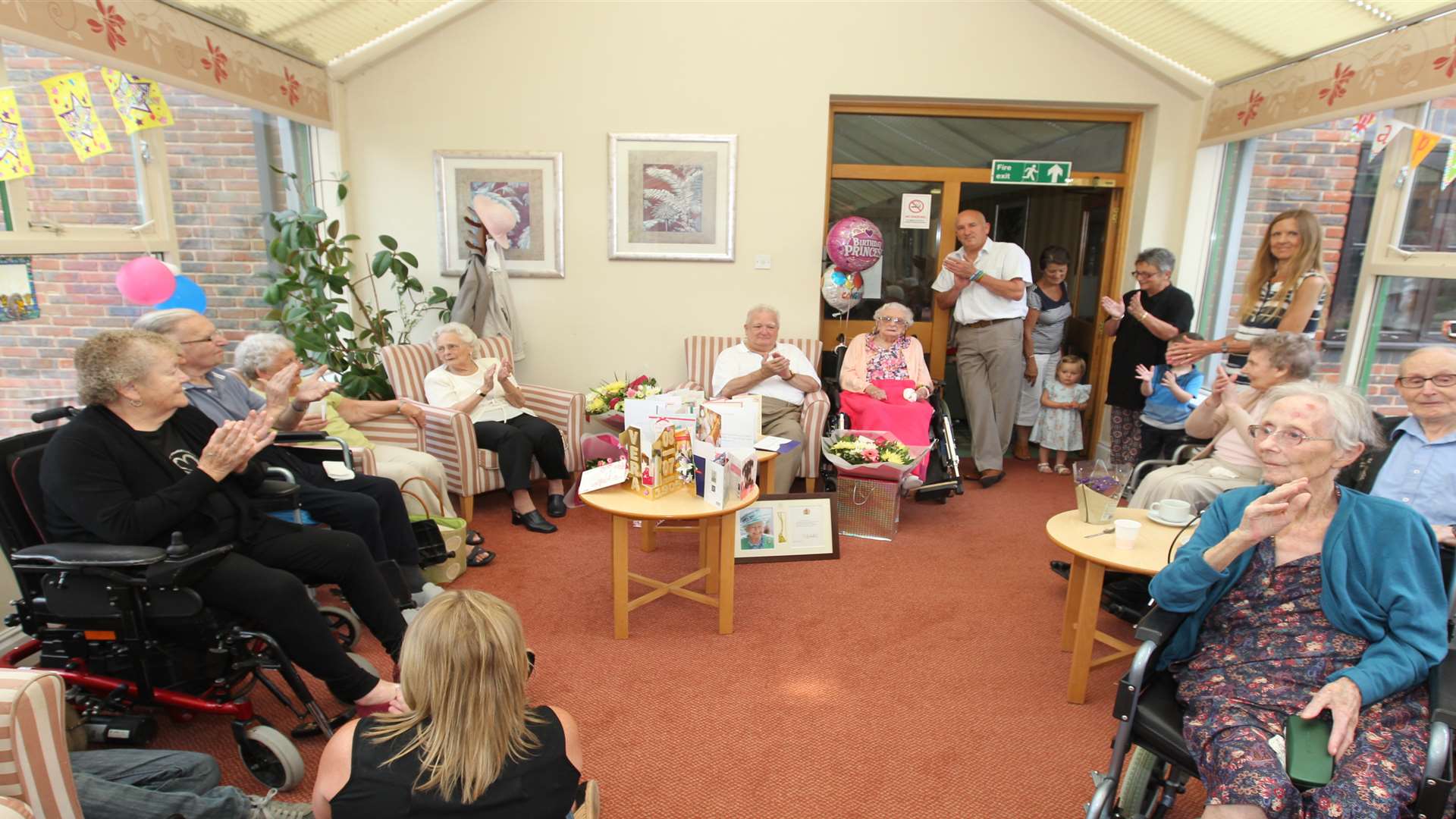 Vera Pigott, celebrates her 110th birthday with from left, Graham Pigott, son and Kevin Lee, grandson and other residents at Sutton Valence Care Home. Picture: John Westhrop.