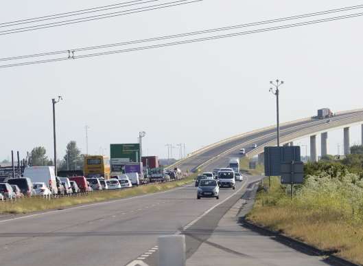 Queues at the crossing, showing the broken down lorry on the bridge. Picture: Barry Hollis