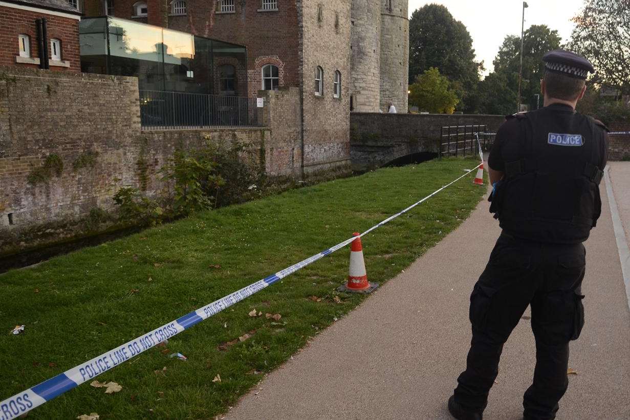 A police officer stands guard by police tape in Canterbury after the tragedy