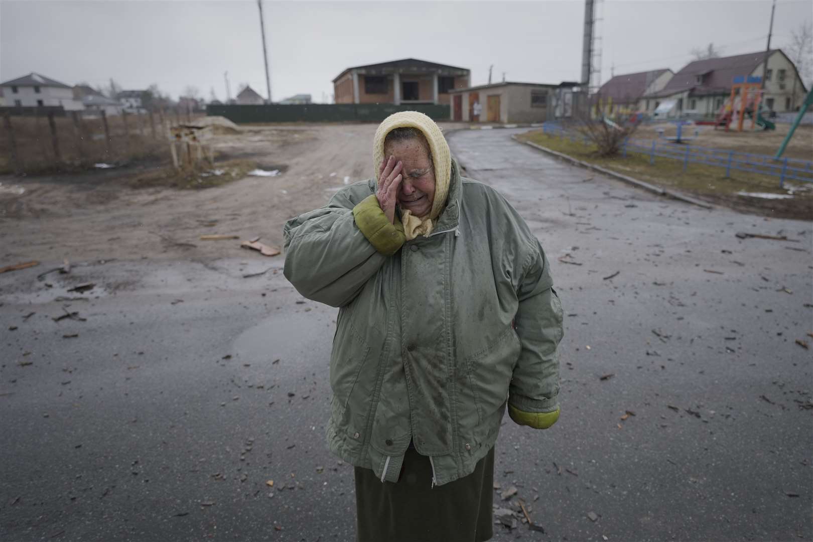 A woman cries outside houses damaged by a Russian airstrike, according to local people, in Gorenka (Vadim Ghirda/AP/PA)