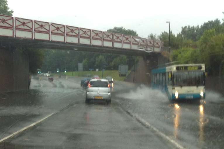 Cars mount the central reservation to avoid flooding in Pier Road, Gillingham
