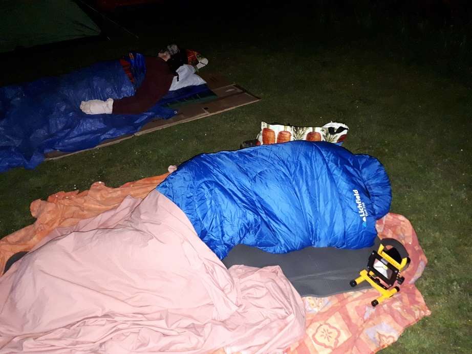 Rough night. The church members sleeping outdoors. (1306263)