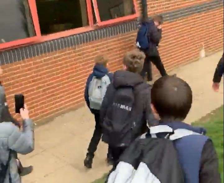 Some pupils were seen filming the incident on their phones. (7994076)