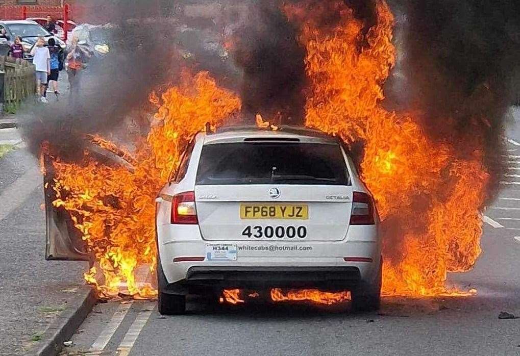 A taxi burst into flames in St Michael's Road, Sittingbourne, earlier today. Picture: Mark Mattocks