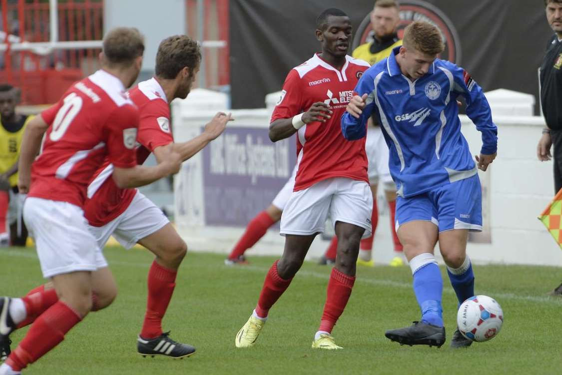 Hythe's Jordan Wells is outnumbered in the FA Cup tie against Ebbsfleet Picture: Andy Payton