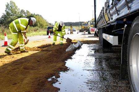 Officials begin a clean up after a shed load of syrup leaks onto the A20
