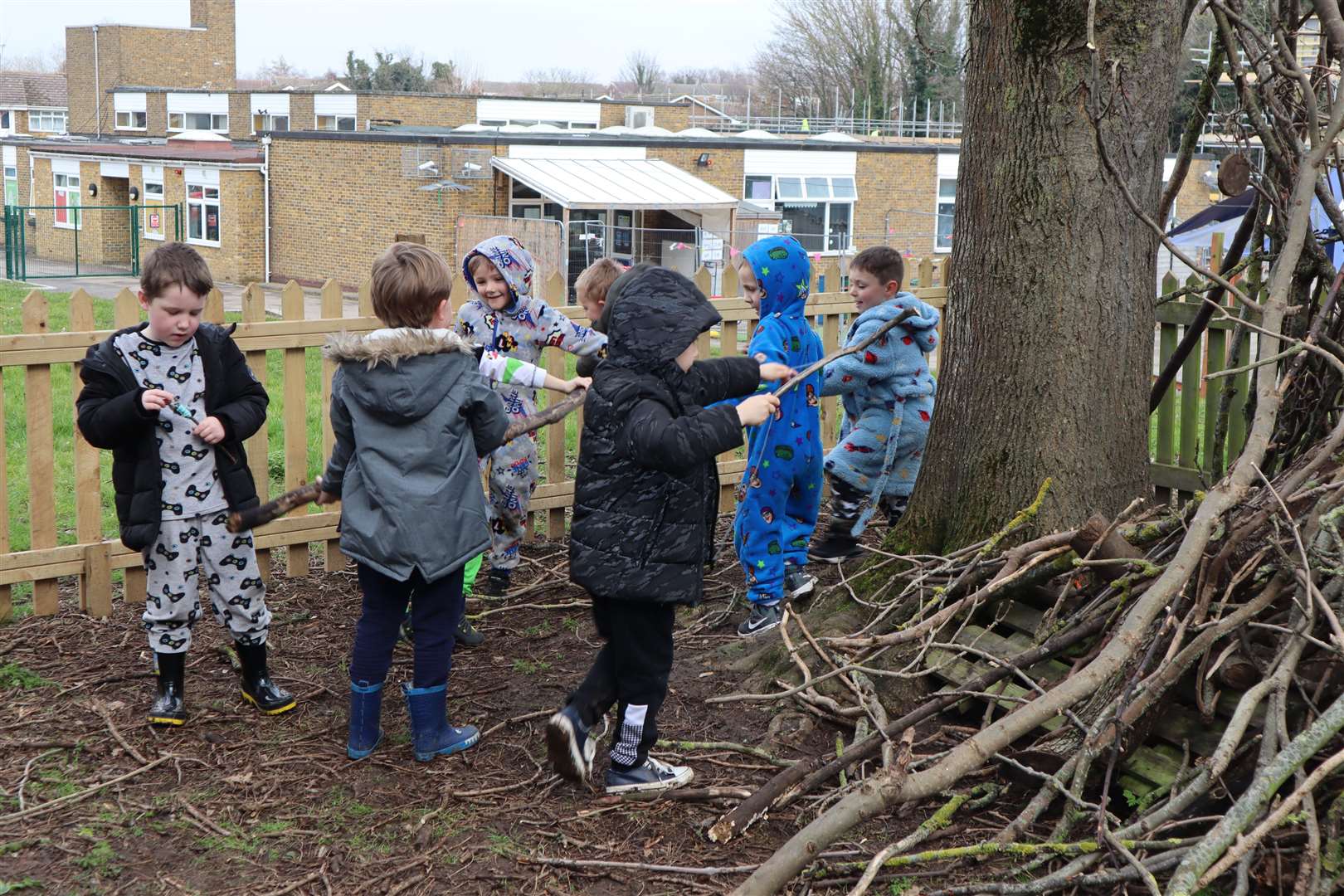 Boys creating a den during forest school at Sunny Bank Primary School