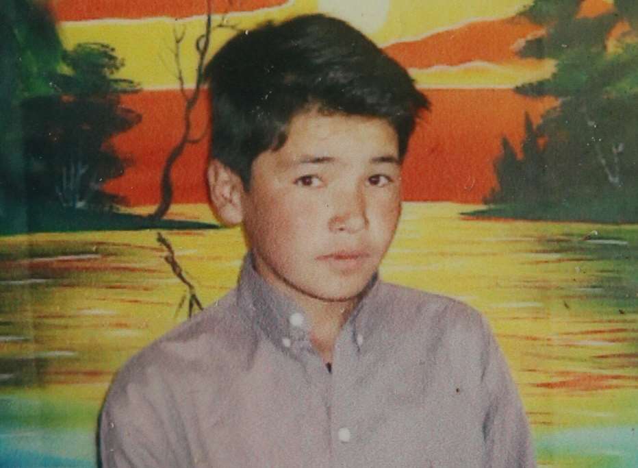 Hossein Gholami, pictured here in Afghanistan aged 12