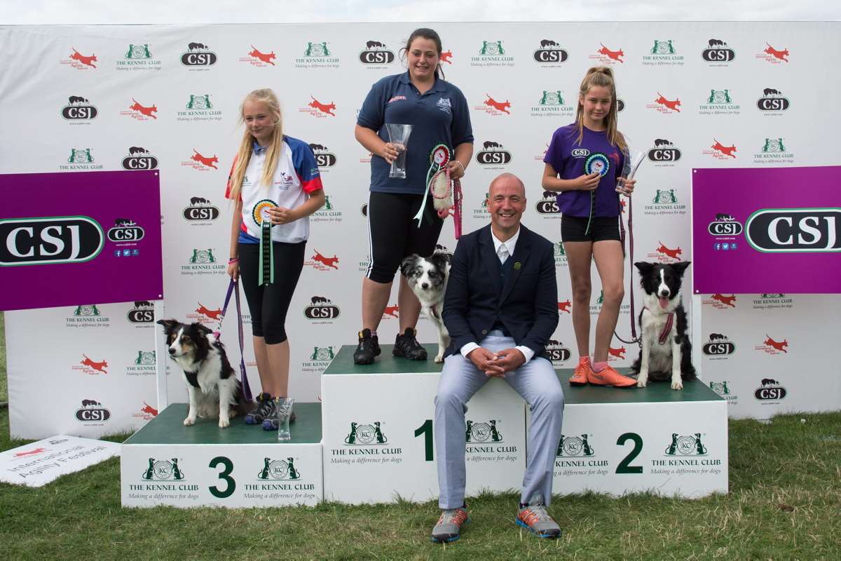 Shannon Springford (centre) was named the International Young Handler of the Year for guiding dog Gift through a complex obstacle course in the best time