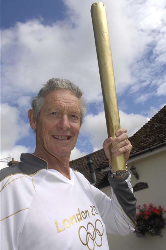 Graham Cooper pictured with a mock-up of an Olympic torch after his nomination for the relay run