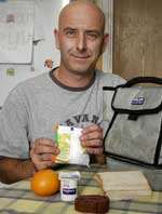 Michael Stupples with the contents of his son Ryan's packed lunch. Picture: PETER STILL