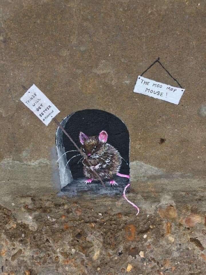 Sheppey's Moo Mop Mouse at home with a placard