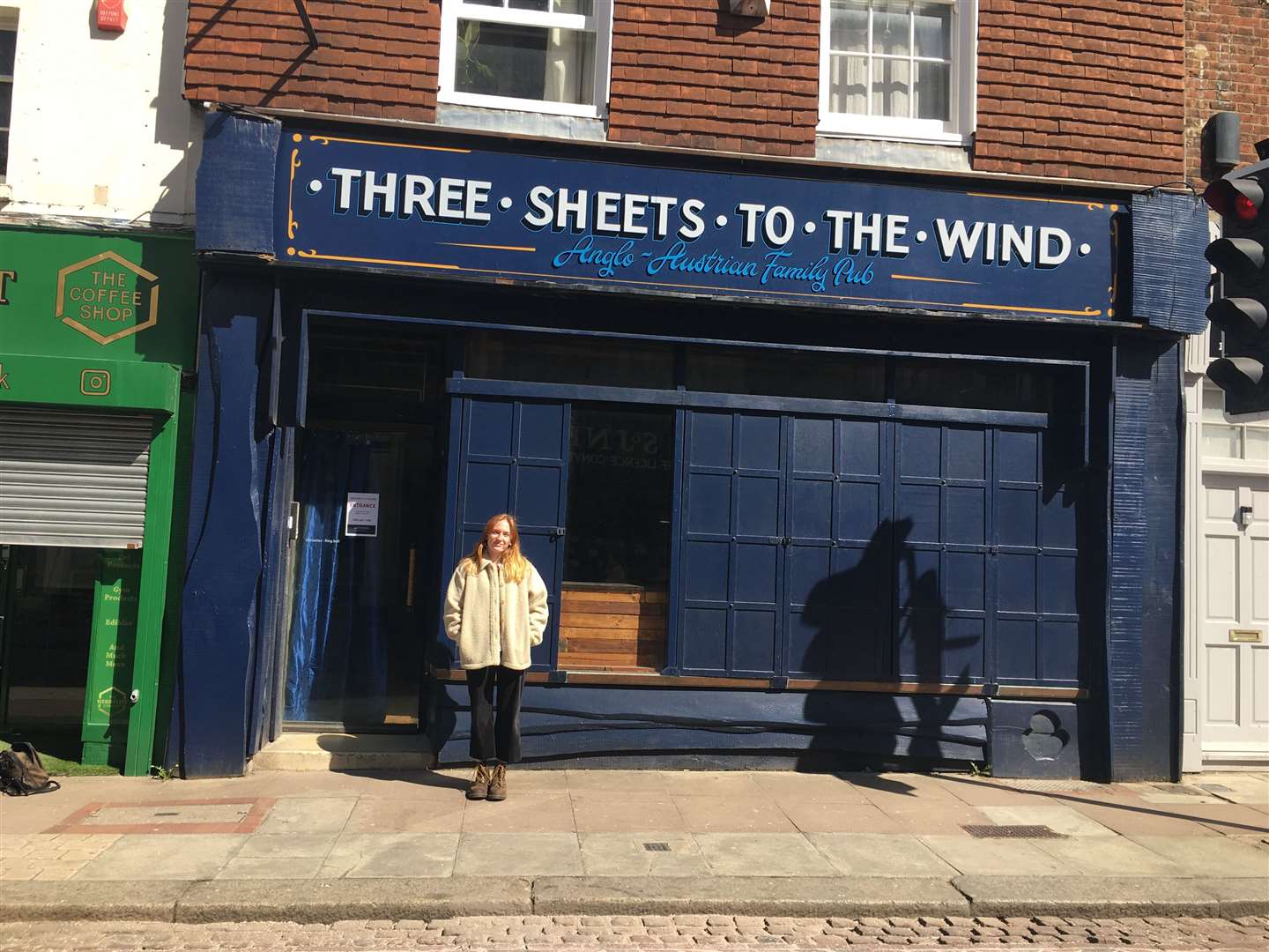 Nina outside of her family-run bar, the Three Sheets to the Wind