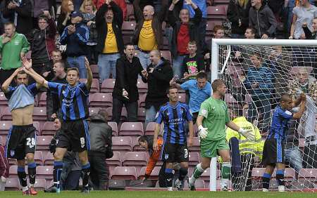 Gillingham's players show their despair as Bradford's late winner goes into the net