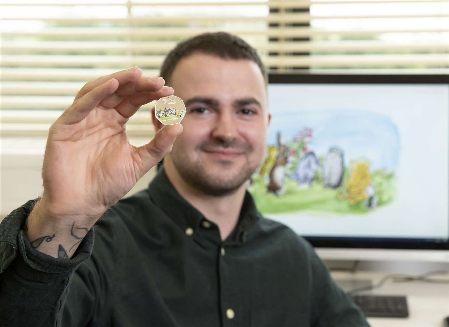 The Royal Mint designer Daniel Thorne with the new Winnie the Pooh and Friends coin