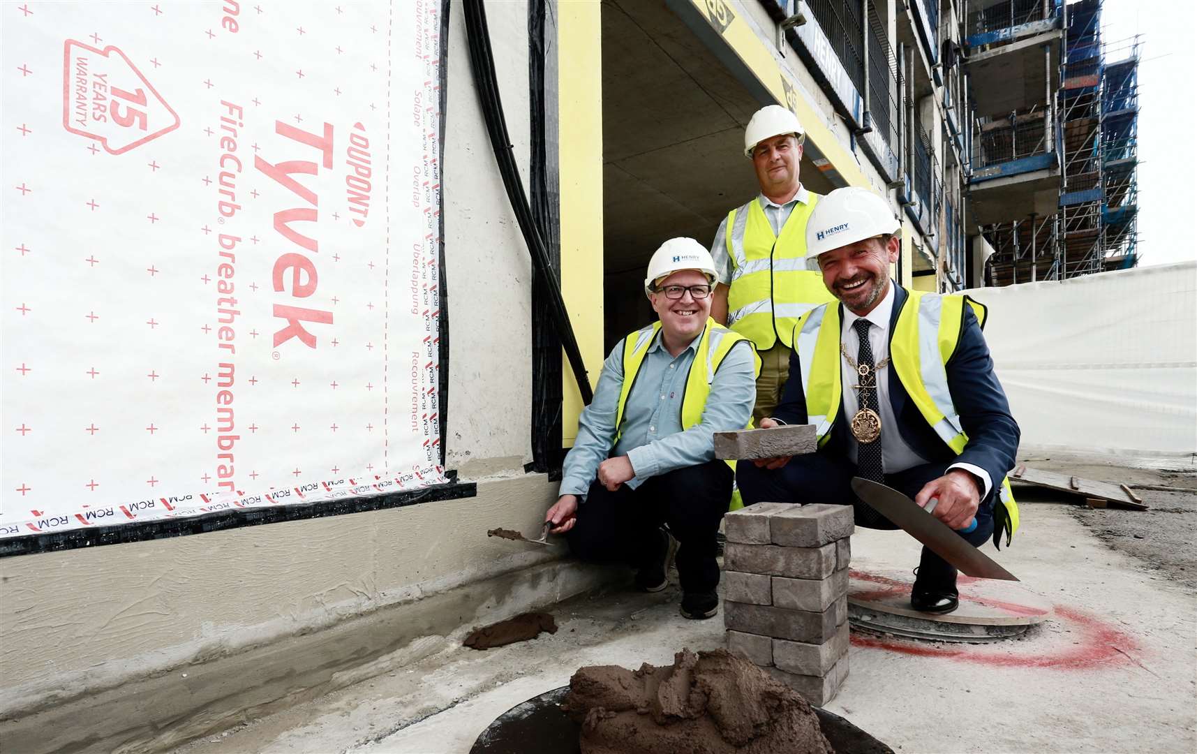 The Mayor of Gravesham Cllr Peter Scollard lays the first brick at The Charter, watched by Cllr John Burden, Leader of Gravesham council, and Cllr Lenny Rolles, chairman of Rosherville, the council’s commercial trading company. Picture: Gravesham Borough Council