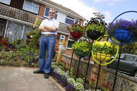 David Stanley, with his olympic-themed garden, with torchbearer and rings, at Nutberry Close, Teynham.