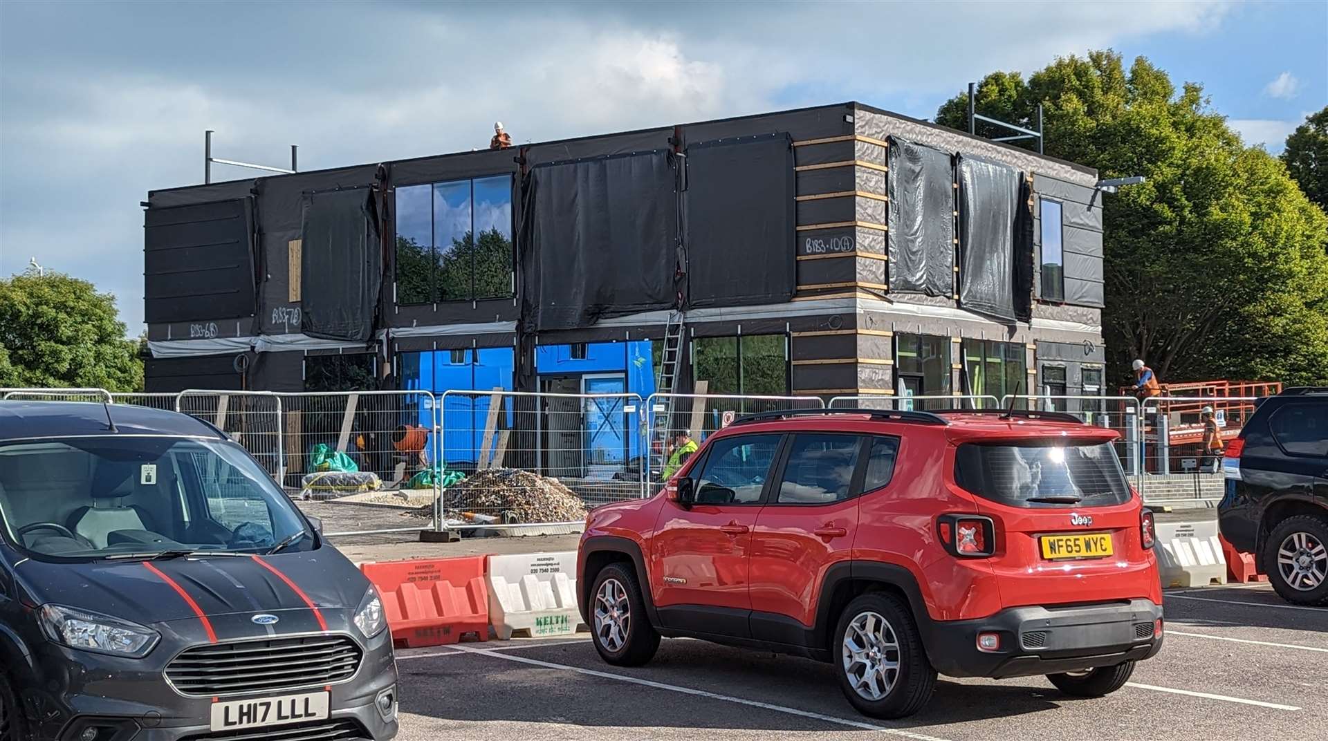 The new McDonald's drive-thru is in the far corner of a supermarket car park
