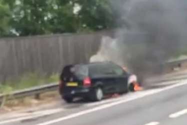 The car was pictured burning on the hard shoulder. Pic by Bethany Hepple