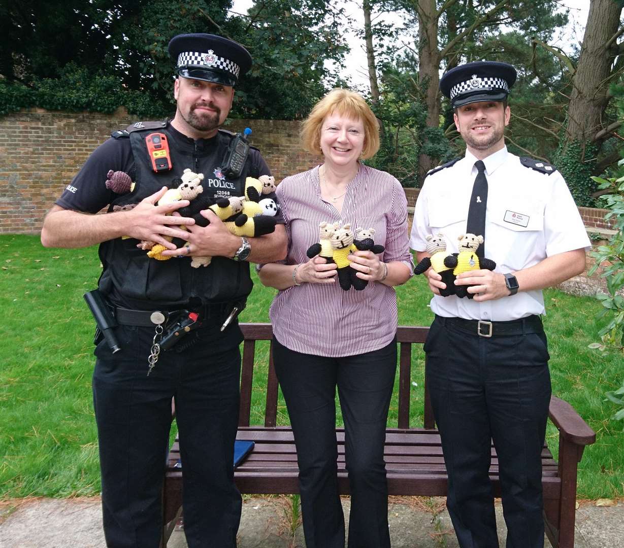 Angela Howells, town clerk of Westerham Council, hands over Bobby Buddies from ‘Knit n Natter’ to Sergeant Pete Ballard and Insp Nick Finnis (4495334)
