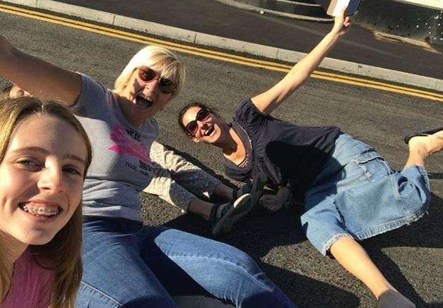 Barming residents Katie and Claire Dadswell and Mia and Liliya Stockwell celebrate the reopening of the A26 Tonbridge Road - by sitting on it!