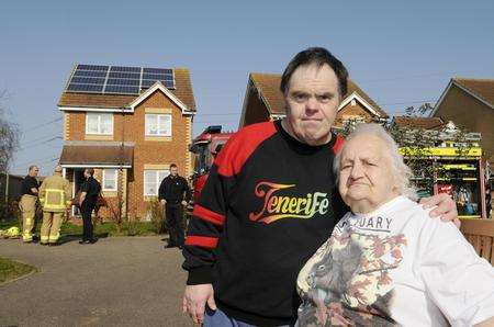 Iris Harvey and son Danny outside their house after the fire