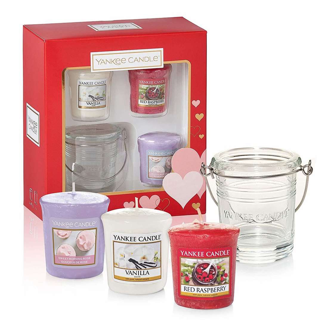This gift includes a vanilla votive, a red raspberry votive, a sweet morning rose votive and a clear glass bucket holder.