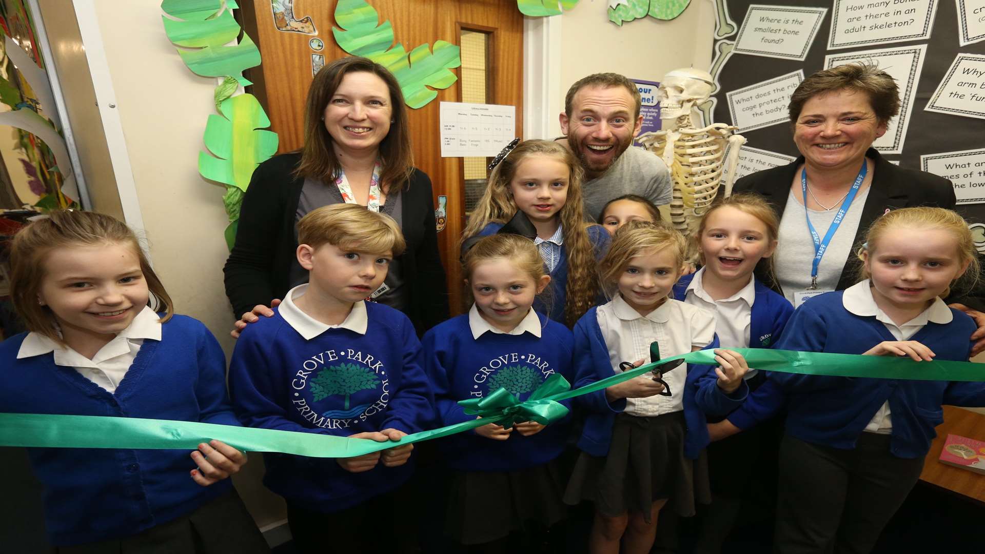 From left, Mrs Wells, Library Coordinator, John Kirk, Storyteller and Miss Litton. Head Teacher and Daisy, nine, cutting the ribbon with other pupils at the official opening of the newly refurbished Grove Park Primary School's library.