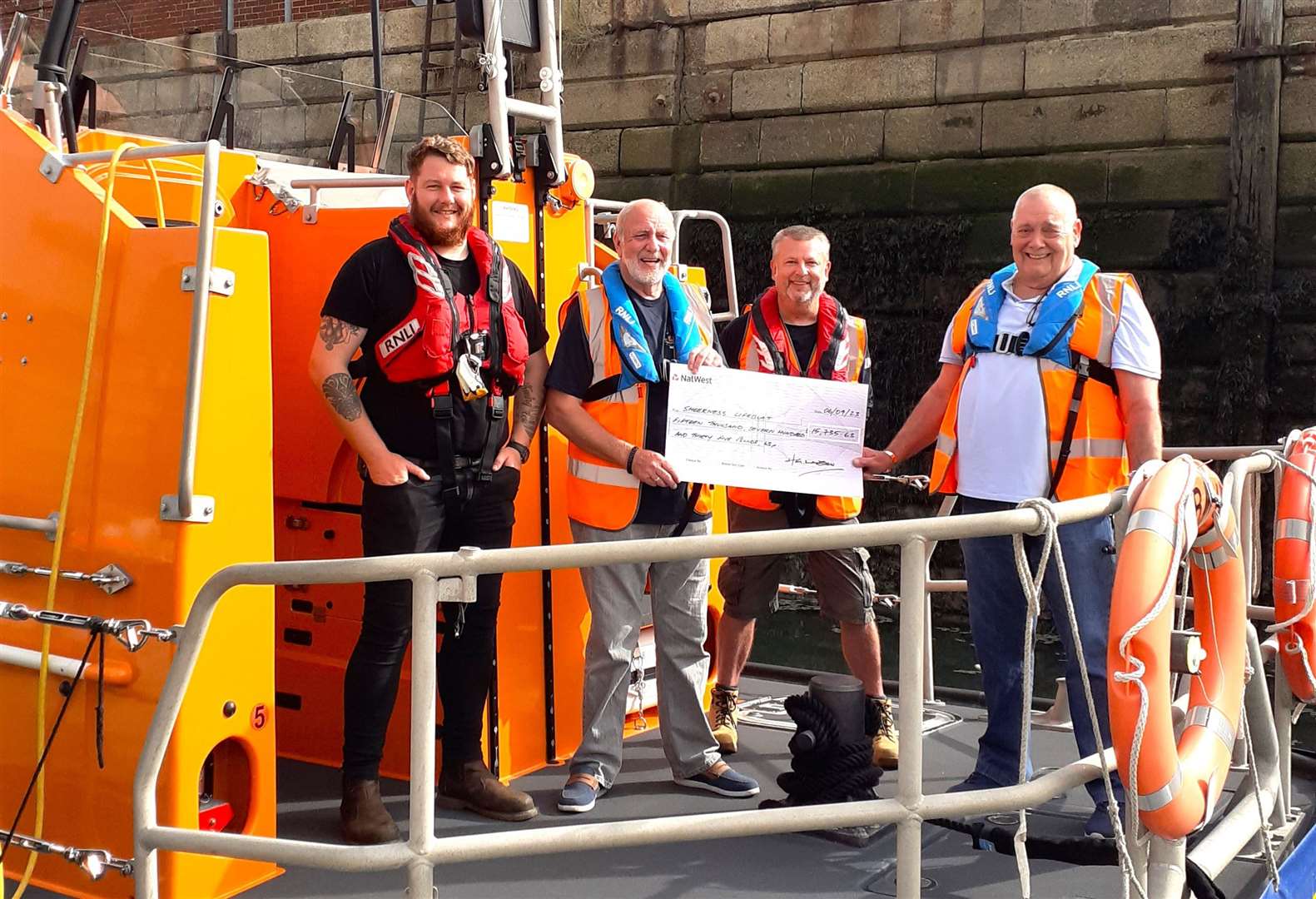 Henry George Lawson's son, Paul, with station treasurer Robin Castle MBE, Nigel Budden, Sheerness lifeboat operations manager and volunteer crew member, Jack Smedley. Picture: RNLI Sheerness